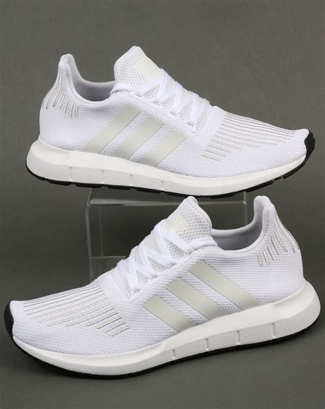 white Adidas athletic shoes